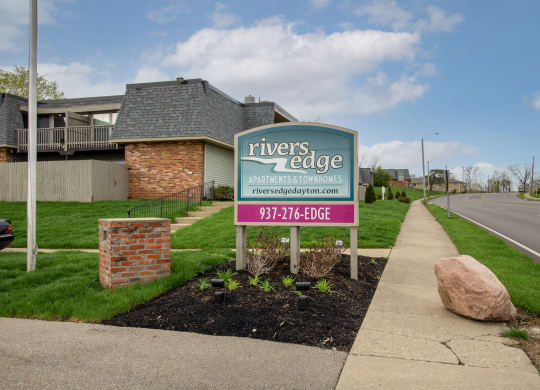 a sign for rivers edge apartments on the side of the street at Rivers Edge Apartments and Townhomes, Ohio