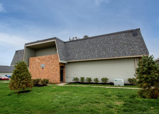 the front of a house with a gray roof and a green lawn at Rivers Edge Apartments and Townhomes, Dayton, 45405