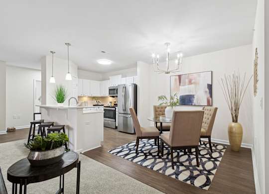 A modern kitchen with a dining table and chairs. at Roebling Row, Covington