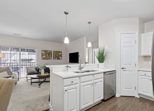 A modern kitchen with white cabinets and a large island. at Roebling Row, Covington, 41011-1720
