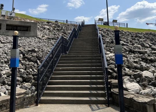 a flight of stairs leading up to the top of a hill