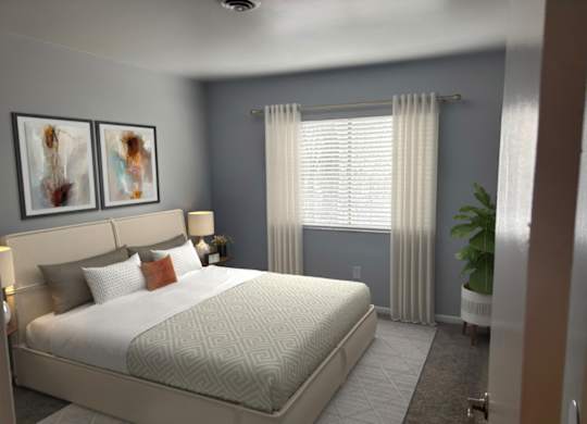 A bedroom with a large bed and two framed pictures on the wall.