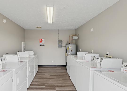 A laundromat with rows of washers and dryers.