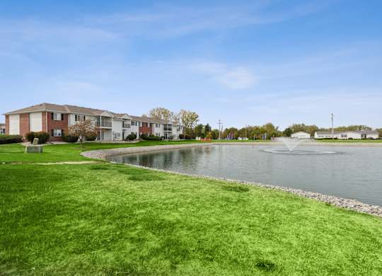 A residential area with a pond and a fountain.