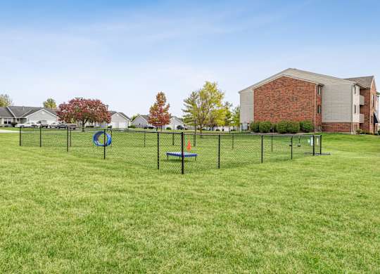 A playground with a swing set and a slide in a grassy area.