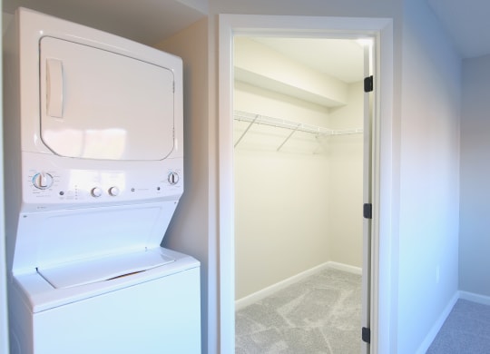 a laundry room with a washer and dryer and a closet