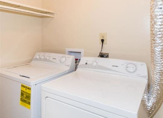 a washer and dryer in a laundry room with a ceiling light