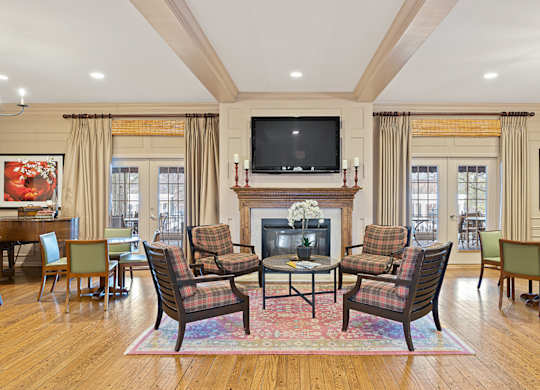 a living room with a fireplace and a table and chairs at Indian Creek Apartments*, Cincinnati, OH