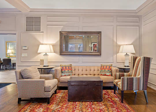 a living room with couches chairs and a table at Indian Creek Apartments*, Ohio