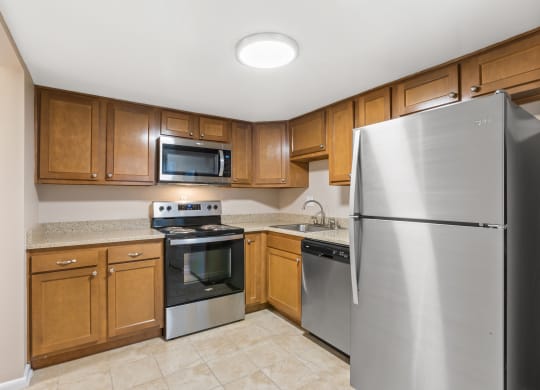 Kitchen with wooden cabinets, a dishwasher, and stainless steel appliances at Merrick Place, 40502