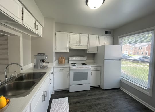 a kitchen with white appliances and white cabinets