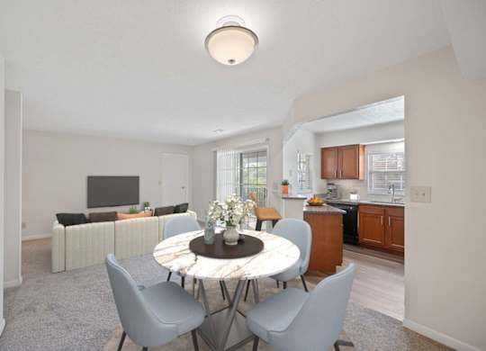 a living room and dining room with a table and chairs at Normandy Club Apartments, Centerville, OH, 45459