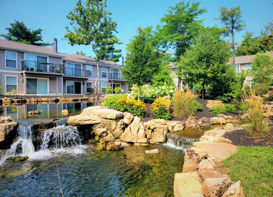 a pond with a waterfall in front of a building at Harpers Point Apartments, Cincinnati, OH, 45249