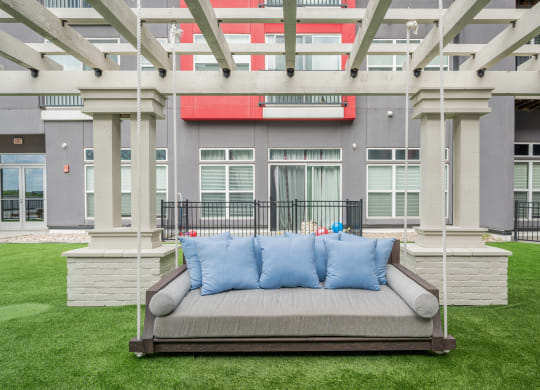 a couch on a lawn in front of a building