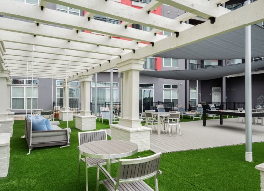 a patio with chairs and tables and a