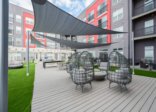 a large patio with chairs and tables and a canopy