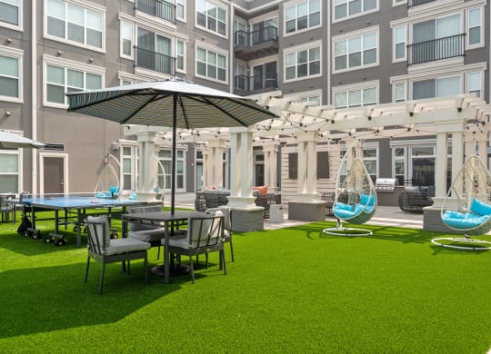 a courtyard with tables and chairs and umbrellas