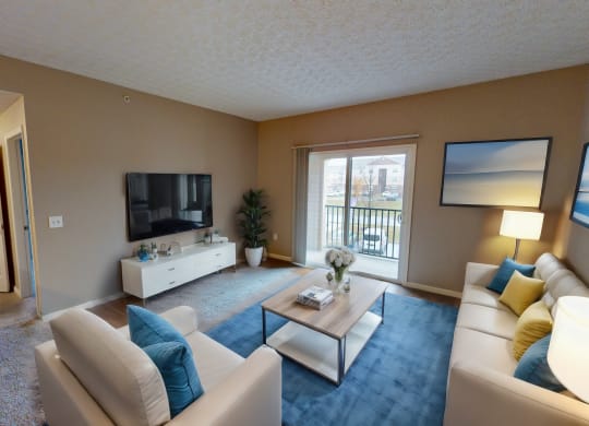 a living room with a couch and a table and a television