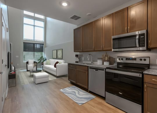 a kitchen and living room with wood floors and stainless steel appliances at Adelphi Quarter, Columbus, 43203