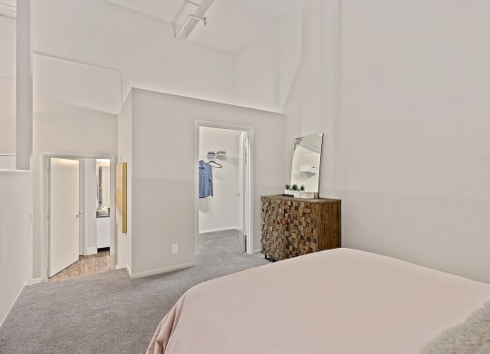 Bedroom with bed and lamps at The Lofts at Shillito Place, Cincinnati, OH