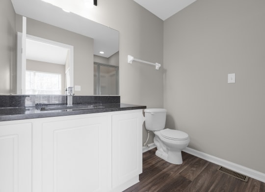 an empty bathroom with a toilet and a sink at Traditions at Slate Ridge, Reynoldsburg Ohio