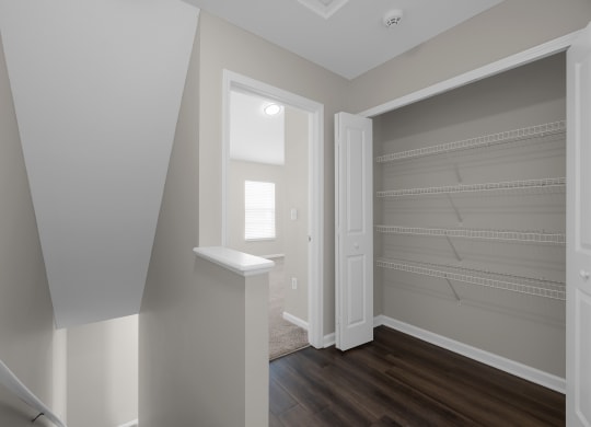 an empty room with a closet with shelves and a window at Traditions at Slate Ridge, Ohio