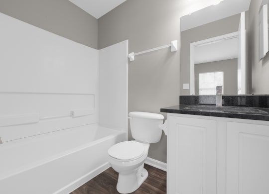 a white bathroom with a toilet and a bath tub at Traditions at Slate Ridge, Ohio, 43068