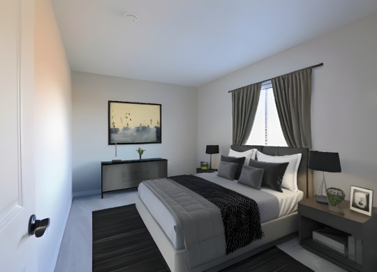 a black and white bedroom with a bed and a window