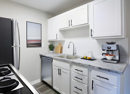 a kitchen with white cabinets and a stainless steel refrigerator