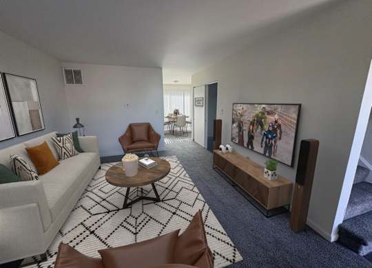 A living room with a couch, chairs, and a coffee table.