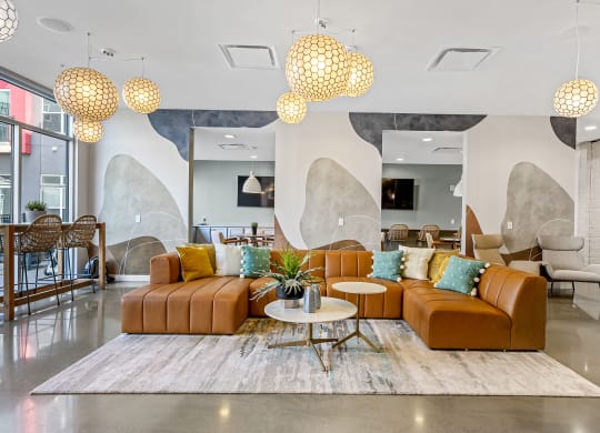 a living room with couches and chairs and a rug