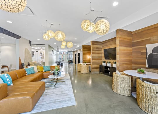 the lobby of a hotel with couches and tables