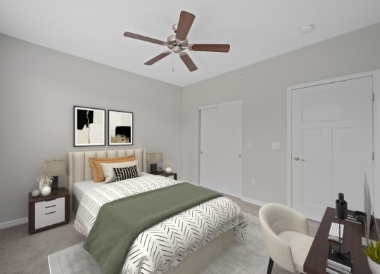 a bedroom with a large bed and a ceiling fan at Monmouth Row Apartments, Newport, KY