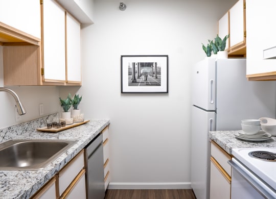 a kitchen with granite countertops and white appliances