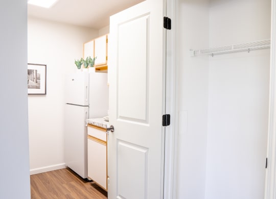 a kitchen with a white refrigerator freezer next to a white door