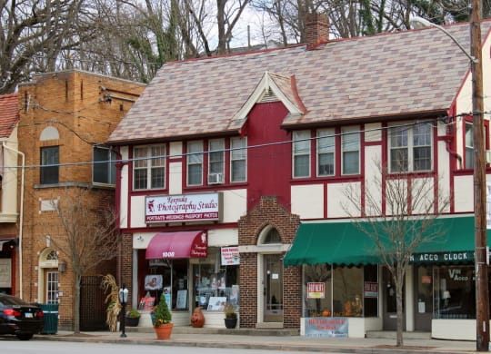 a red and white building on the corner of a street