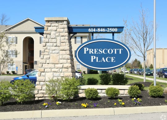 the place monument sign in front of the front yard of a building