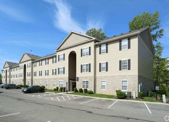 a large apartment building in a parking lot