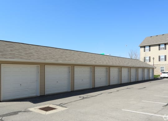 a garage with white doors and a roof