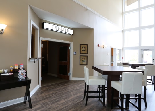 a dining room with a table and chairs and a door