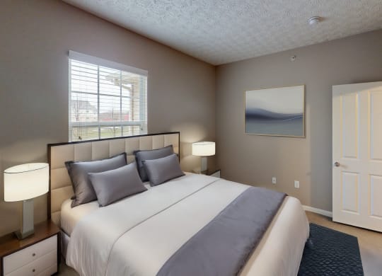 a bedroom with a large bed and a window