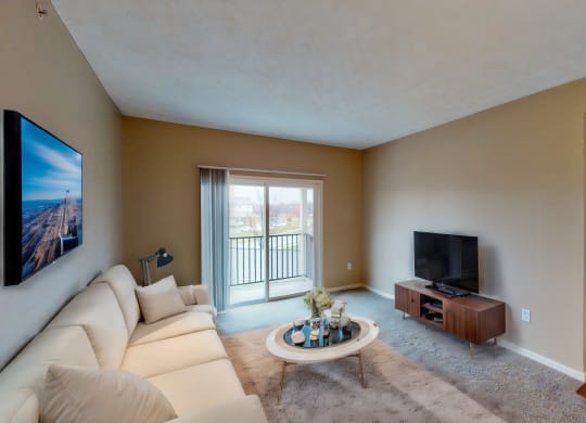 a living room with a white couch and a tv
