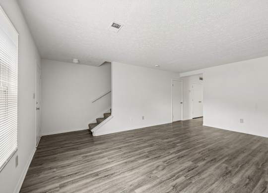 A room with wooden floors and white walls.