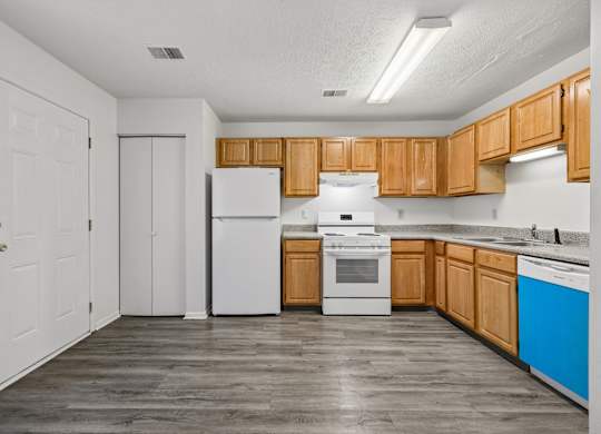 A kitchen with wooden cabinets and white appliances.