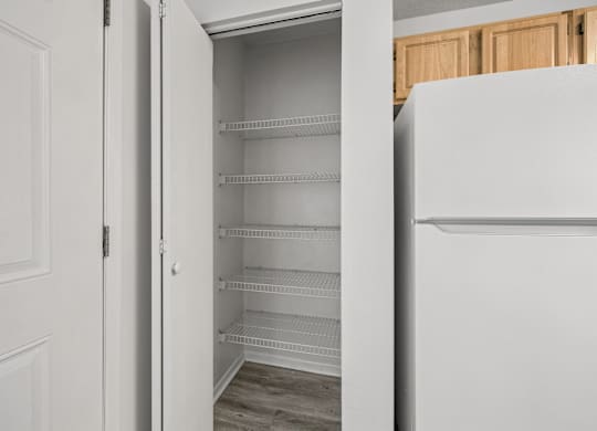 A white refrigerator with its door open in a kitchen.