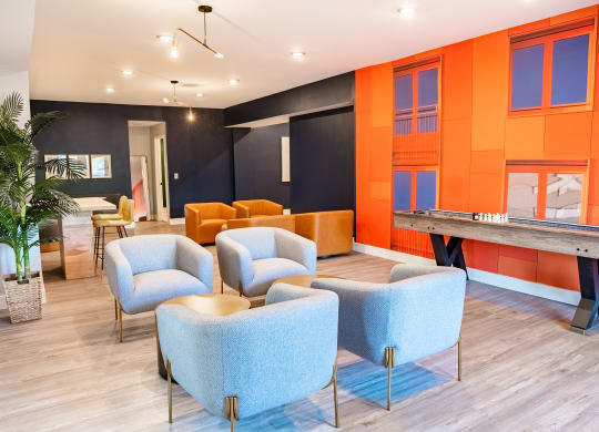 a room with blue chairs and orange walls