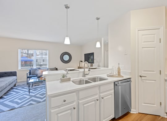a kitchen with an island and a living room in the background at Roebling Row, Covington, 41011-1720