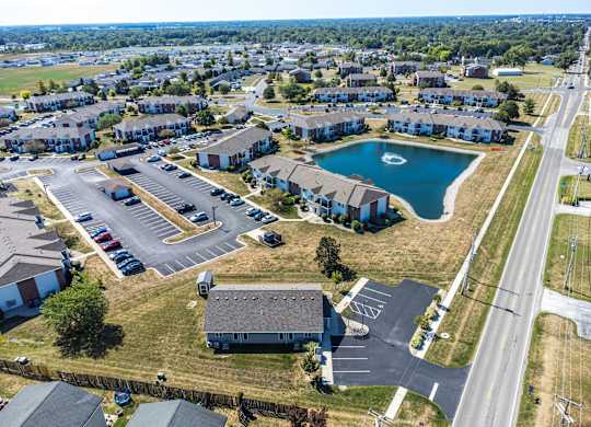 A bird's eye view of a residential area with a swimming pool and apartment buildings.