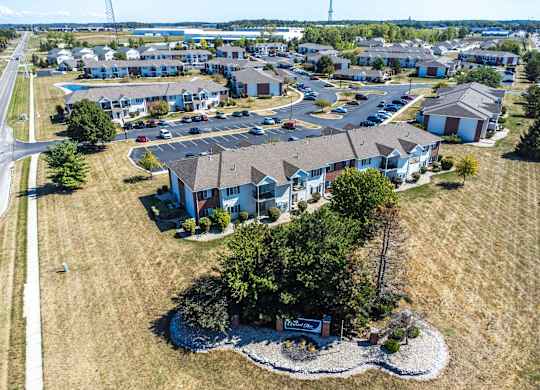 A bird's eye view of a residential area with houses and a sign in the foreground.