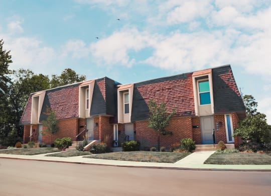 a brick house with a sidewalk in front of it